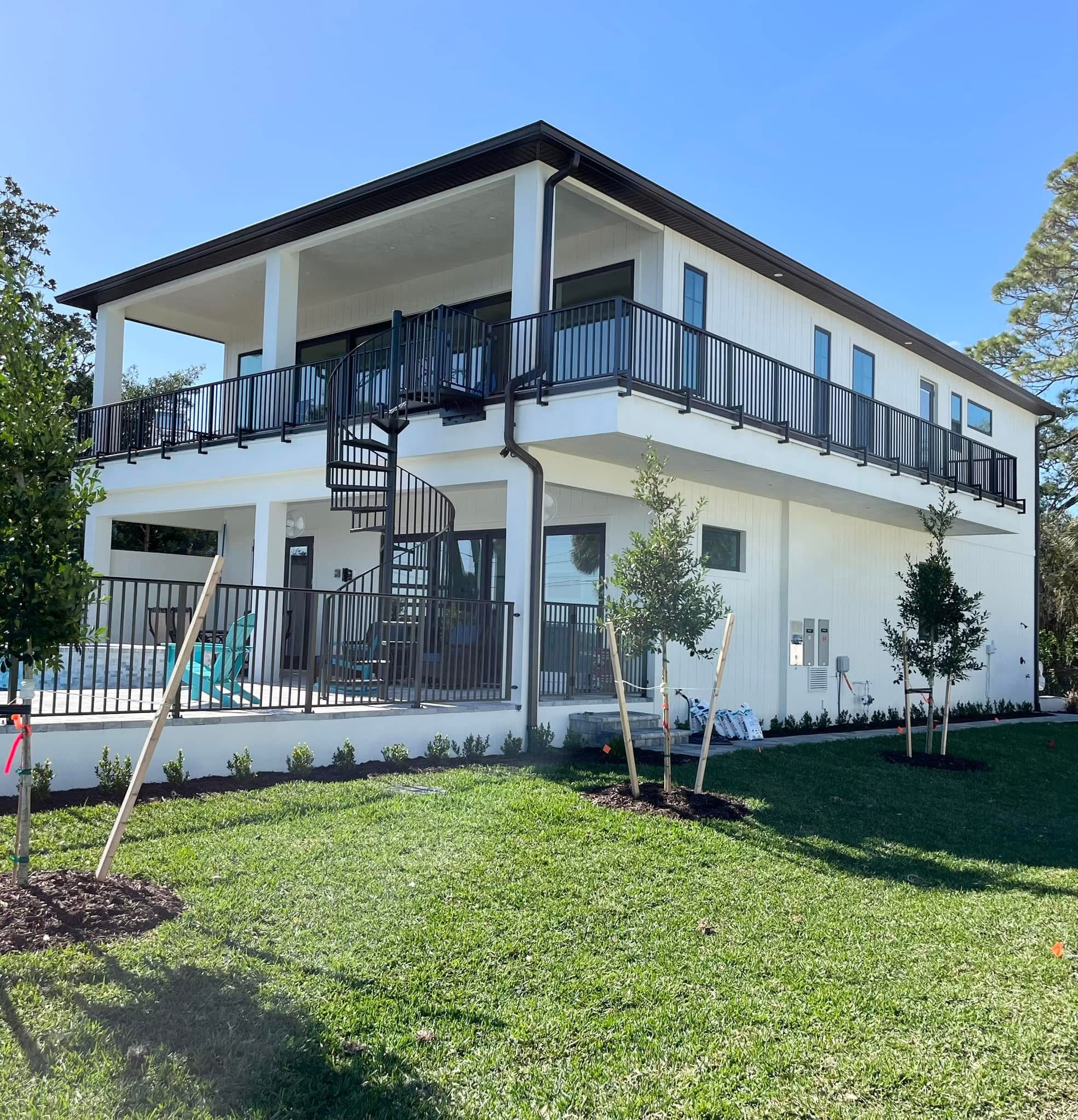 Coastal home rear elevation and spiral staircase