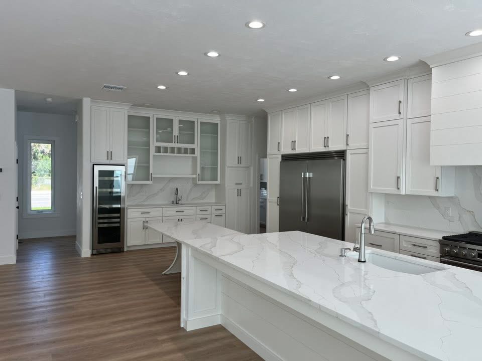 Kitchen with quartz waterfall island and custom cabinetry