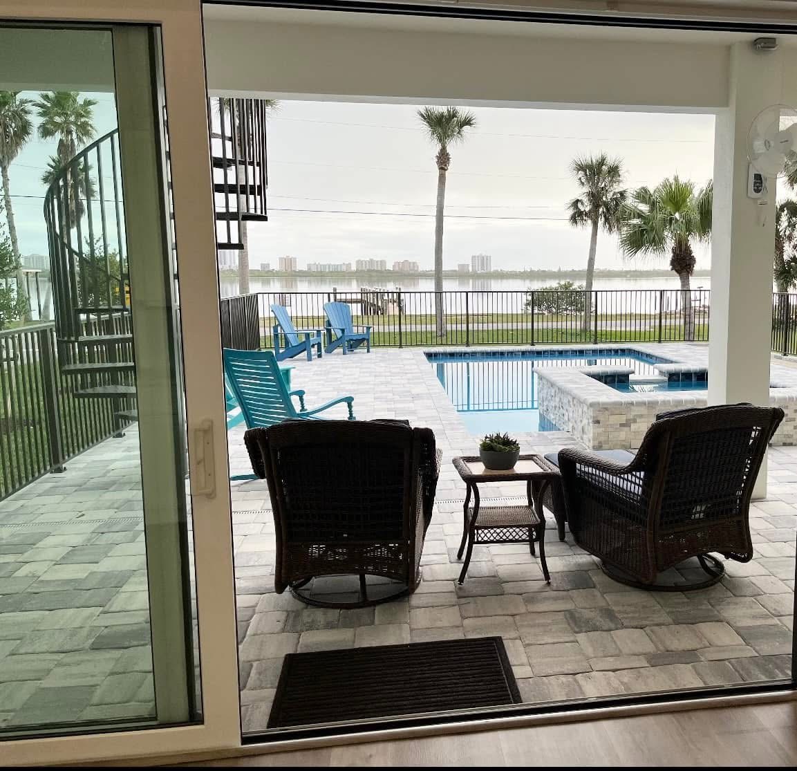 Covered waterfront lanai beside a Niagara Builders pool